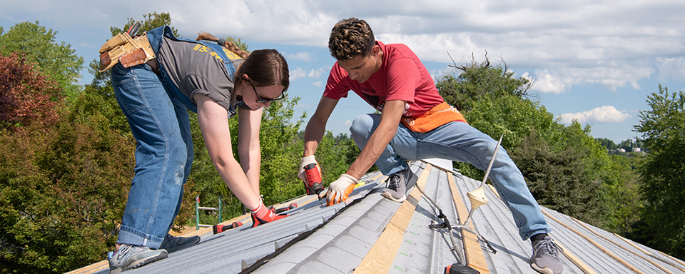 students working on a roof