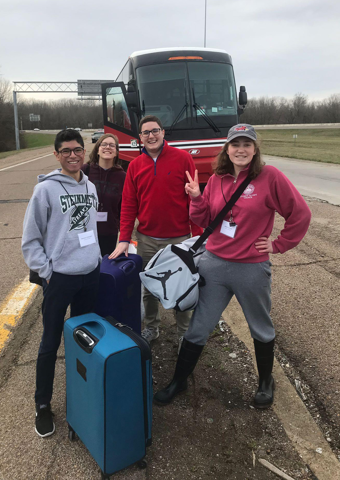 Students in front of a charter bus