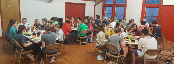 Students eating at a campground during ASB